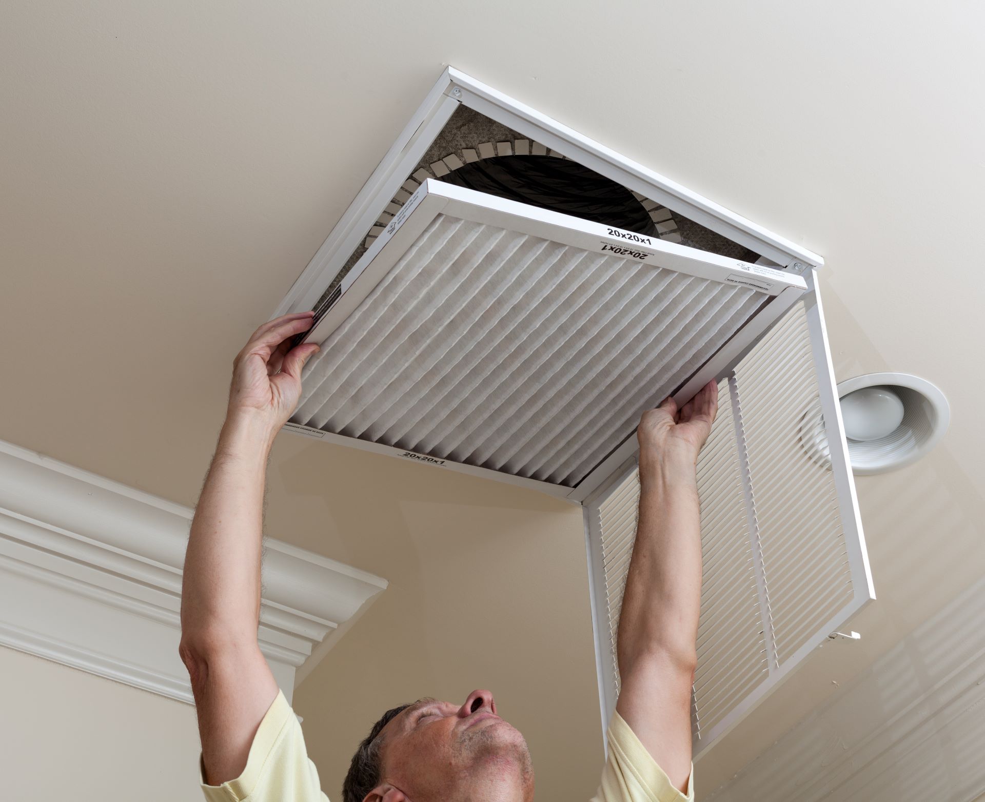 Man changing home ventilation filters