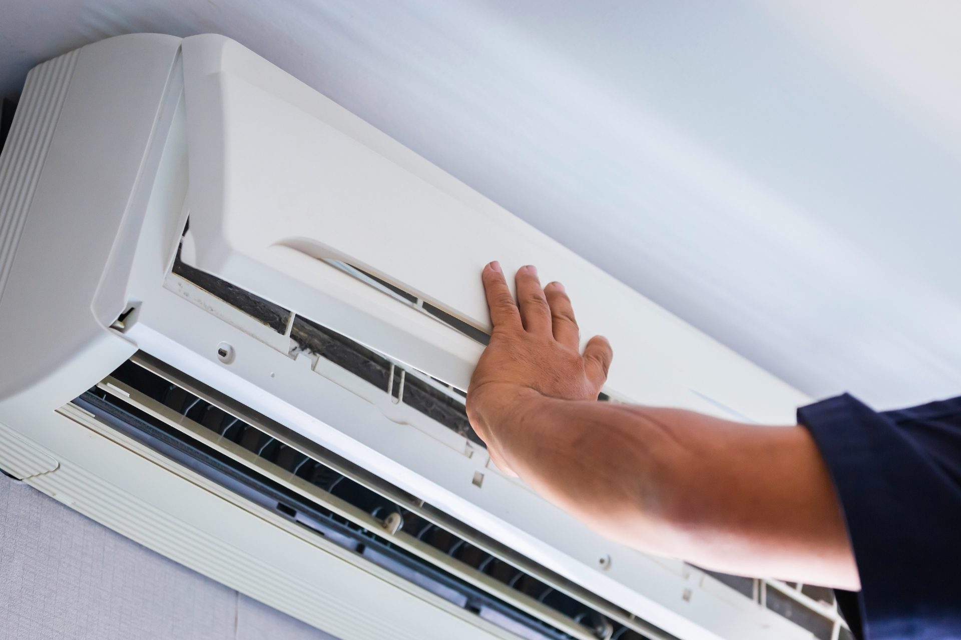 Man servicing air conditioning unit