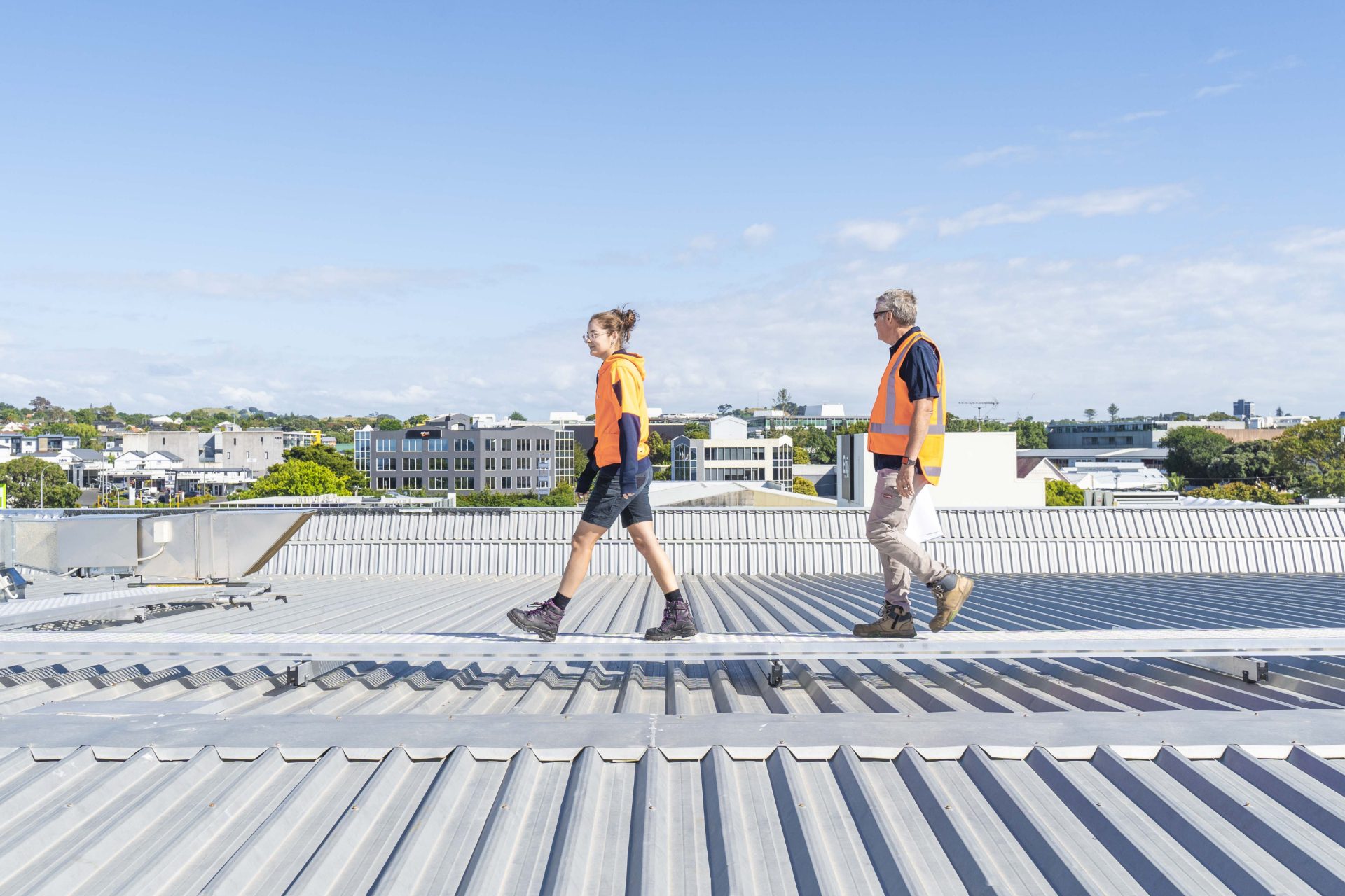 HVAC specialists inspecting ventilation on roof in Auckland
