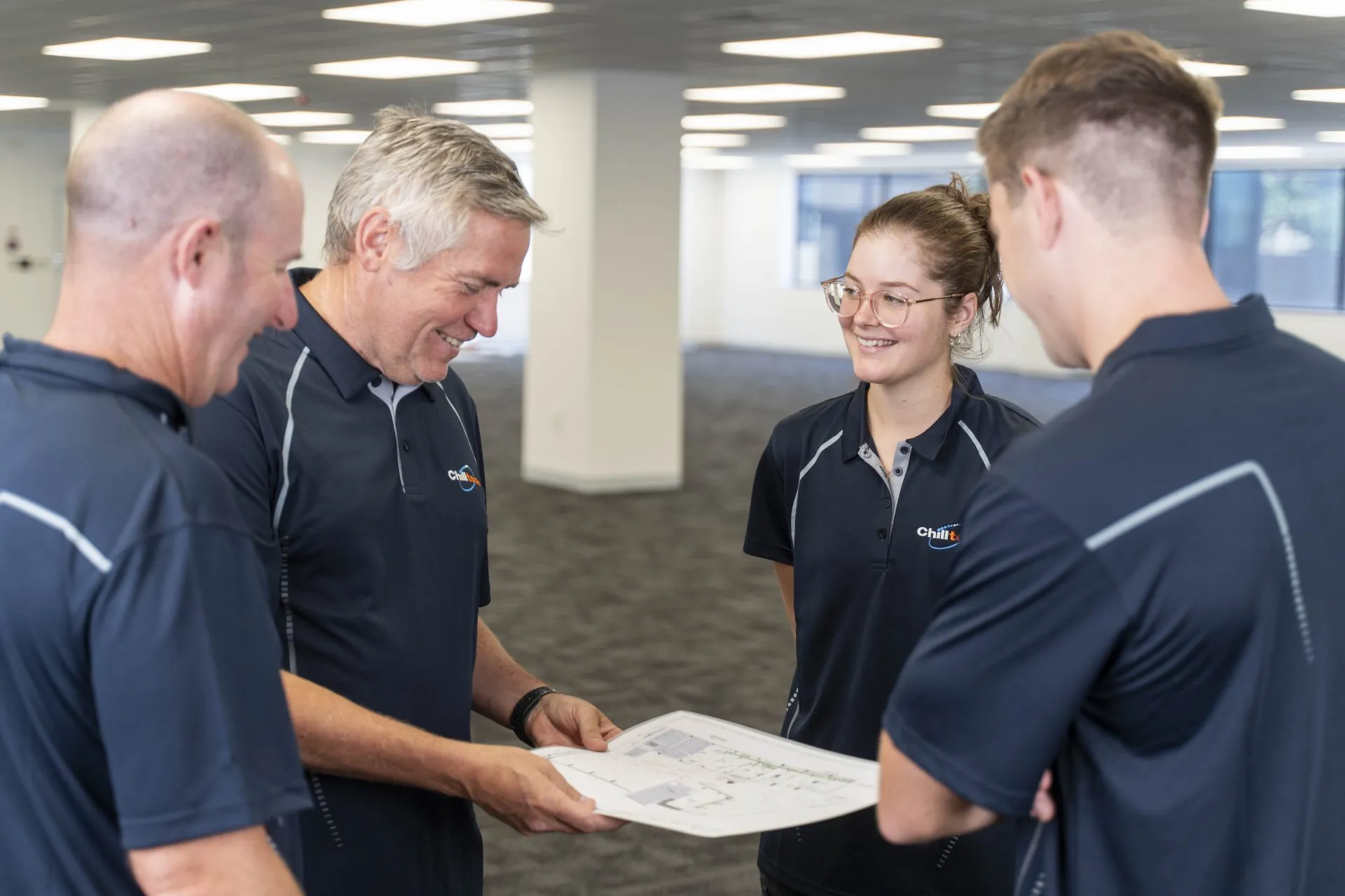 Chilltech staff discussing plans in Auckland office