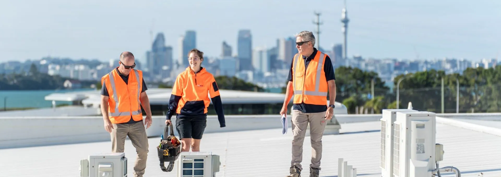 Chilltech employees inspect HVAC installation on Takapuna rooftop